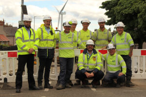 A group of gas engineers with turbine in the background